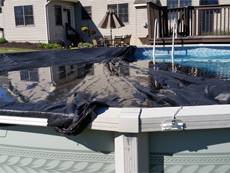 drape cover across pool pulling over ropes